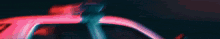 a blurred image of a car with a red background