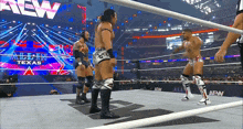 a group of wrestlers are standing in a ring with a sign that says allin texas