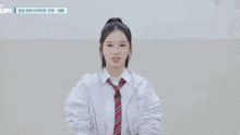 a girl wearing a white shirt and tie with the word upi on the bottom