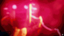 a blurred image of a person 's face with a red light behind them
