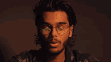 a man wearing sunglasses has a reflection of a kiwi fruit in his glasses