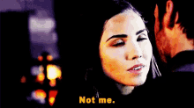 a woman is talking to a man and says " not me " .