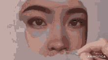 a person is painting a woman 's face with a brush
