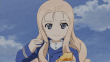 a girl in a blue jacket is eating a piece of cake with a fork