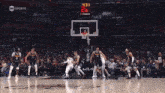 a basketball game is being played in front of a crowd and the score is 19 to 19