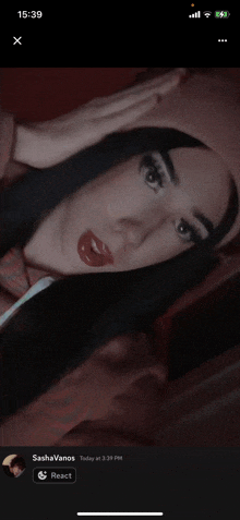 a phone screen shows a picture of a woman with red lipstick