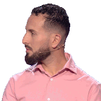 a man with a beard wears a pink shirt and a microphone around his neck