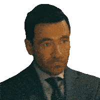 a man in a suit and tie looks to his left