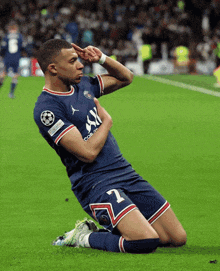 a soccer player with the number 27 on his shorts is kneeling on the field