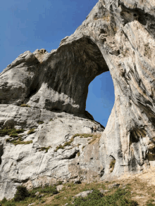 a large rock formation with a large arch in the middle of it