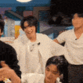 a group of people are sitting in a room and one of them is laughing .