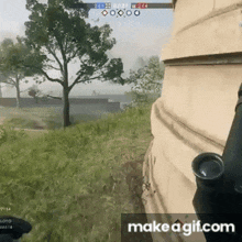 a person is holding a gun in a video game while standing next to a building .