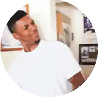 a man in a white t-shirt is standing in a circle .