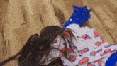 a girl laying on the floor wearing a shirt that says ' a ' on it