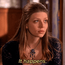 a woman wearing a necklace with the words it happens on the bottom