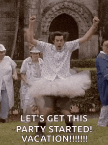 a man in a tutu is jumping in the air while a group of people watch .