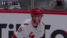 a hockey player with the number 37 on his jersey celebrates a goal
