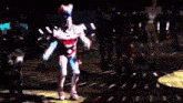 a woman in a robot costume is dancing on a stage .