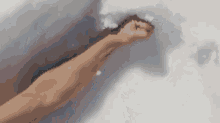 a close up of a person 's fist being thrown into the air .
