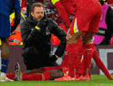 a soccer player in red socks with lfc on the side