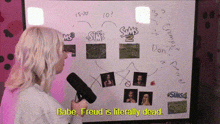 a woman is holding a microphone in front of a whiteboard that says babe freud is literally dead
