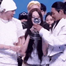 a man is holding a trophy in front of a woman .