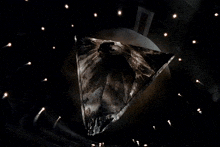 a triangle shaped object is surrounded by lights