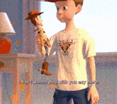 a boy in a toy story shirt holds a woody doll
