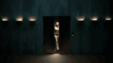 a woman in a white dress is standing in an elevator
