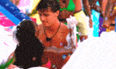 a man and a woman are kissing in a pool of bubbles