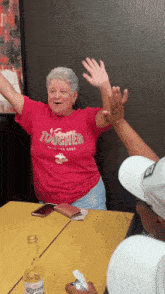 a woman in a red shirt that says tougher on it