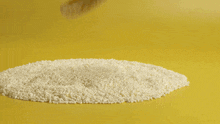 yellow frosting is being piped on a cookie