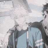 a couple of anime characters standing next to each other . one of the characters is wearing headphones .