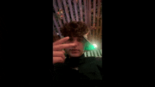a young man wearing a visor and a headband is taking a selfie .
