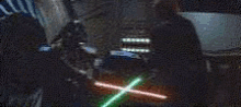 two lightsabers are crossed over each other in the dark .