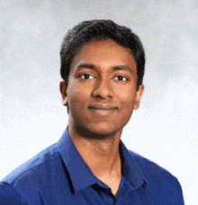 a man wearing a blue shirt looks at the camera
