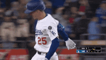 a baseball player with the number 25 on his jersey is running