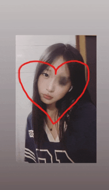 a girl with a black eye has a heart drawn around her face