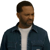 a man with a beard is wearing a denim shirt and a white shirt