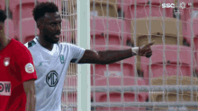 soccer player wearing a white shirt with a mc logo