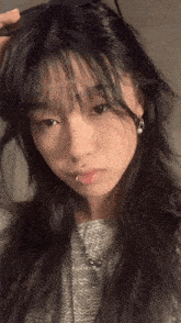 a girl with a piercing in her lip is taking a picture of herself