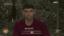 a man wearing a givova shirt with the name jey