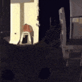 a person is standing on a stool in a dark room