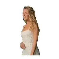 a woman in a white lace dress stands with her hands on her hips