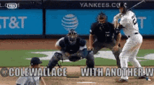 a baseball player is swinging a bat at a pitch while another player watches