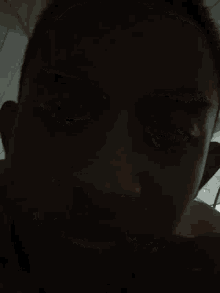 a close up of a man 's face with his eyes closed and his mouth open