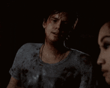 a man with blood on his face is standing next to a woman in a dark room