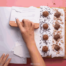 a person is decorating a cake with chocolate and sprinkles and the words mr.cakes on the bottom right