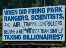 a billboard asks when did firing park rangers scientists and air traffic controllers