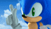 a close up of sonic the hedgehog making a peace sign with his finger